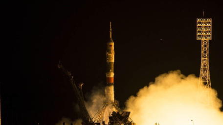 Rocket Launch into the Night Sky with Vibrant Flames and Smoke wallpaper