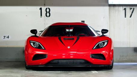 Stunning Red Supercar Displayed in Garage Artistry wallpaper
