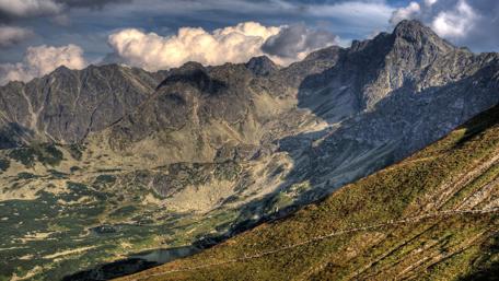 Majestic Mountain Landscape Under Cloudy Sky wallpaper