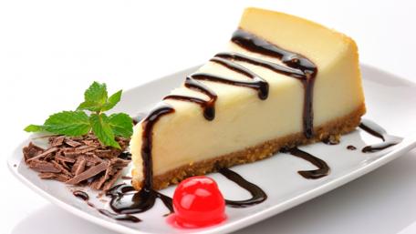 Decadent Cheesecake Slice with Cherry Topping wallpaper