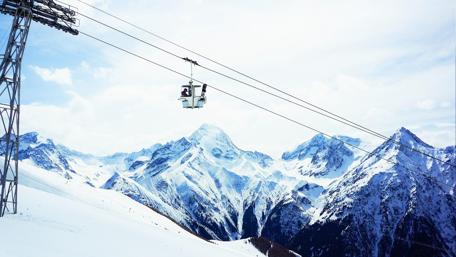 Majestic Snowy Mountain Landscape with Ski Lift View wallpaper
