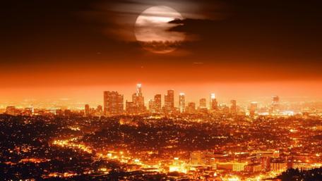 Stunning City Lights Under a Full Moon wallpaper