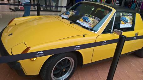 Classic Yellow Sports Car in Display Setting wallpaper