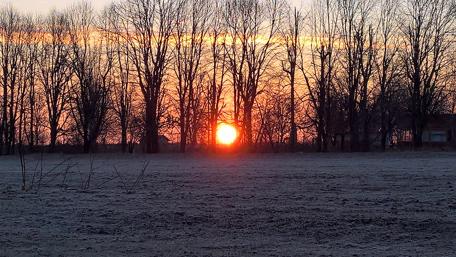 Serene Sunset Over a Winter Field wallpaper
