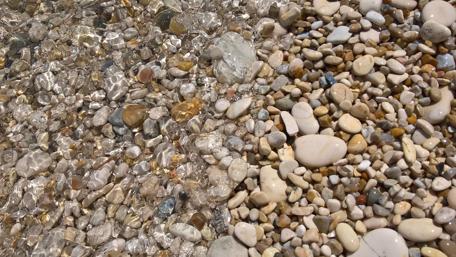 Tranquil Waters Over Pebbles in Nature wallpaper
