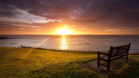 Serene Sunset Over Ocean Coastline 4K Wallpaper wallpaper