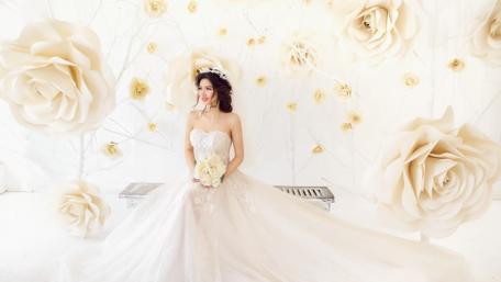 Elegant Bride Surrounded by Whimsical Roses wallpaper