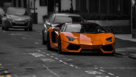 Orange Lamborghini Essence on Monochrome Street wallpaper
