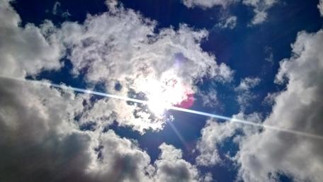 Radiant Sunlight Behind Dramatic Clouds wallpaper