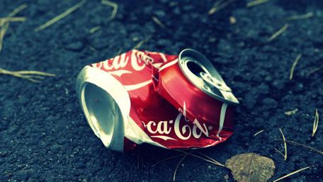 Discarded Coke Can on City Street Pavement wallpaper