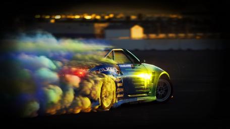 Dynamic Racing Car with Colorful Smoke Effects wallpaper