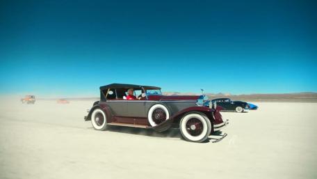 Classic Cars Racing on a Sunny Day wallpaper