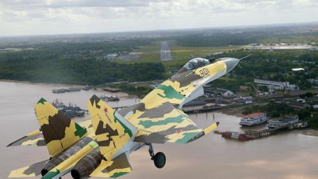 Combat Jet in Flight Over Scenic Landscape wallpaper