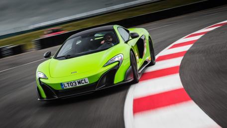 Vibrant MCLAREN 675LT Racing on Track wallpaper