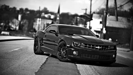 Sleek Black Chevrolet on Urban Streets wallpaper