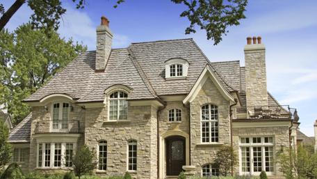 Elegant Stone Mansion Surrounded by Lush Greenery wallpaper