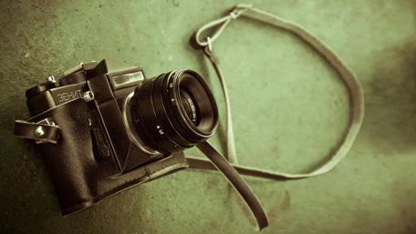 Vintage Camera in Leather Case for Photography Lovers wallpaper