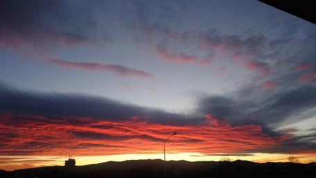 Vibrant Sunset Over Mountain Silhouettes wallpaper