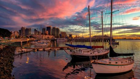 Serene Sunset Over a Harbor City Scene wallpaper