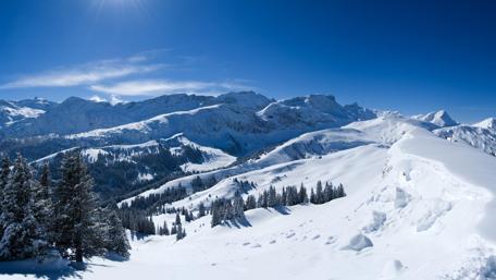 Majestic Winter Mountains Under Clear Blue Sky wallpaper