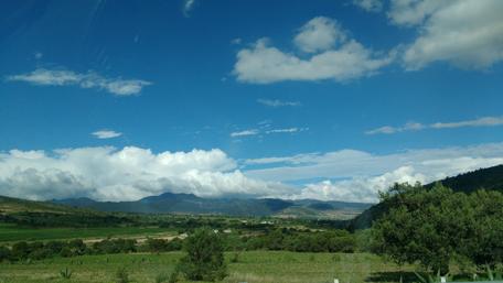 Serene Mountain Landscape Under Blue Sky wallpaper