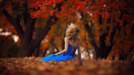 Autumn Serenity in Blue Dress with Falling Leaves wallpaper
