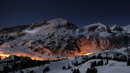 Starry Winter Night Over Snowy Peaks wallpaper