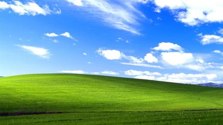 Vibrant Green Hills Under Blue Skies wallpaper