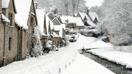 Winter's Embrace on Quaint Village Street wallpaper