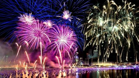 Fireworks Over Cityscape New Year Celebration wallpaper