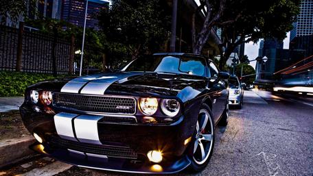 Iconic Muscle Car on a Night Street Scene wallpaper