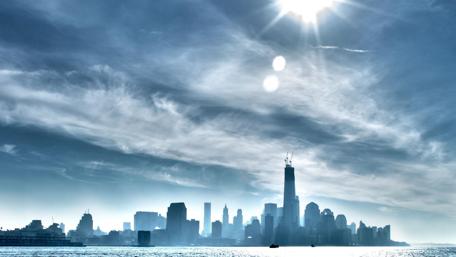 Radiant Cityscape Under Sunlit Sky wallpaper