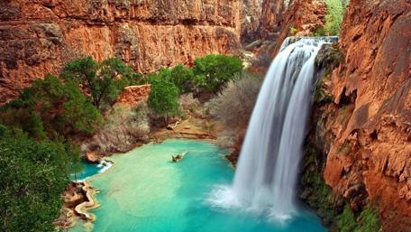 Majestic Waterfall Oasis in Nature's Haven wallpaper