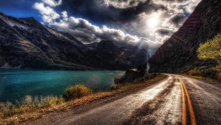 Sunlit Mountain Road Adventure wallpaper