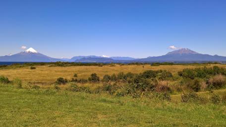 Majestic Volcanoes Under a Clear Sky wallpaper