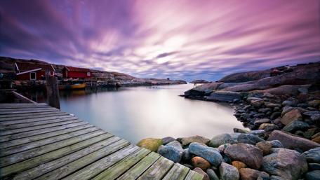 Serene Lakeside Pier Under Dramatic Sky wallpaper