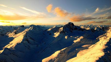 Majestic Mountain Peaks Under Golden Sunset wallpaper