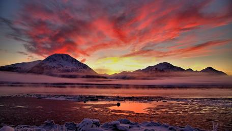 Stunning Sunset Over Tranquil Waters and Mountains wallpaper