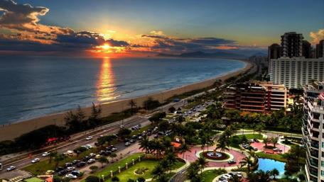 Sunset Over a Coastal Cityscape wallpaper
