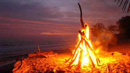 Warm Glow of Beach Campfire at Night wallpaper