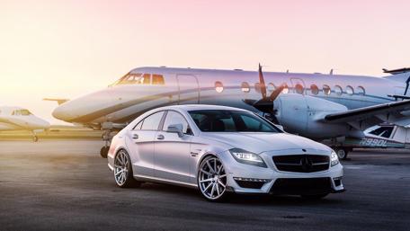 Sleek Mercedes Against a Private Jet Backdrop wallpaper