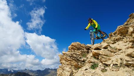 Thrilling Mountain Biking Adventure on Rocky Terrain wallpaper
