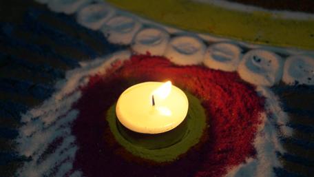 Celebrating Diwali with Lights and Rangoli Artwork wallpaper