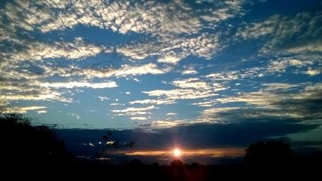 Serene Sunset Over Cloudy Skies wallpaper