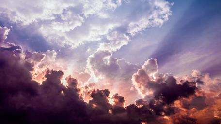 Radiant Sunrays Breaking Through Clouds in the Sky wallpaper
