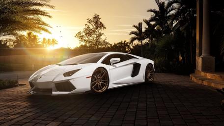 Sleek White Aventador Under Golden Sunset Light wallpaper