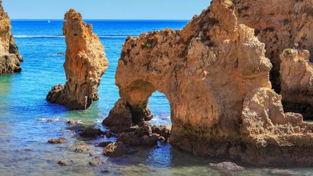 Majestic Rocky Sea Landscape Rising from Tranquil Waters wallpaper