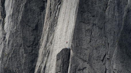 Huge cliff with a climber wallpaper
