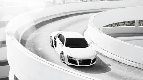 Sleek White Sportscar on Unique Urban Ramp wallpaper