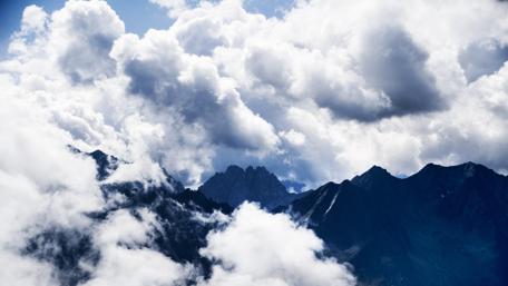Majestic Peaks Beneath a Cloudy Sky wallpaper